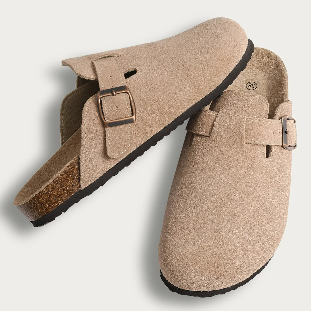 Tan suede cork mules with leather straps and arch support shown from the side.
