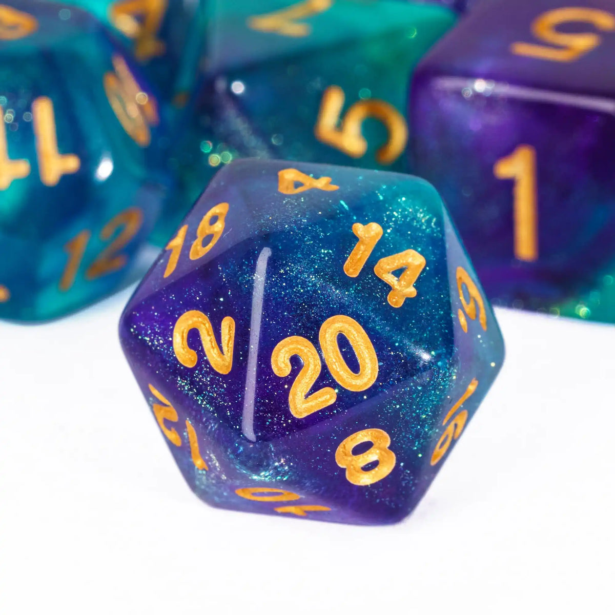 A close-up of a translucent purple polyhedral die with gold glitter numbers resting on a white surface.