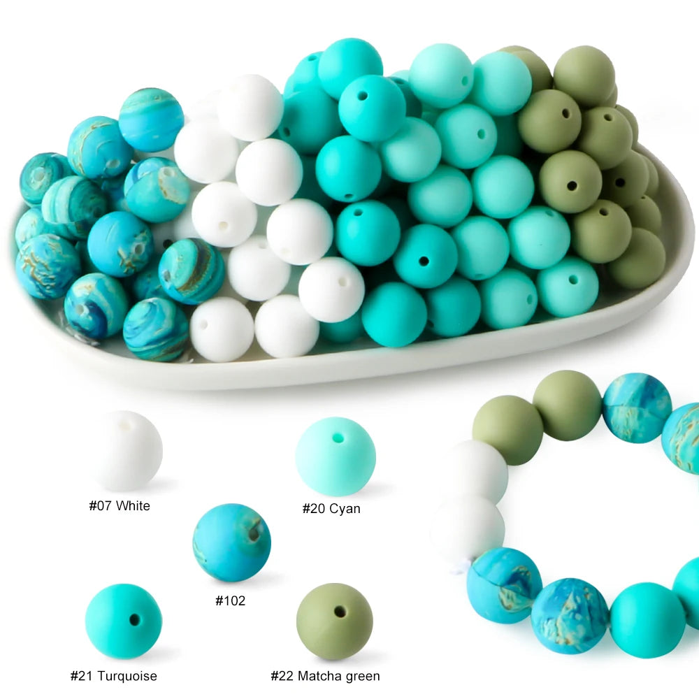 A collection of soft food-grade silicone beads in various shades of blue, white, and green.