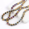 A strand of iridescent purple and gold glass star spacer beads for jewelry making