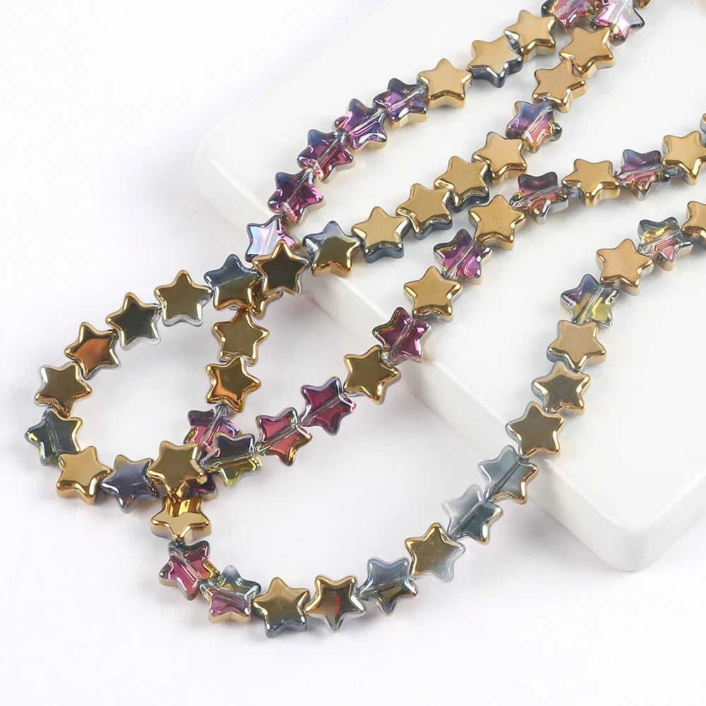 A strand of iridescent purple and gold glass star spacer beads for jewelry making