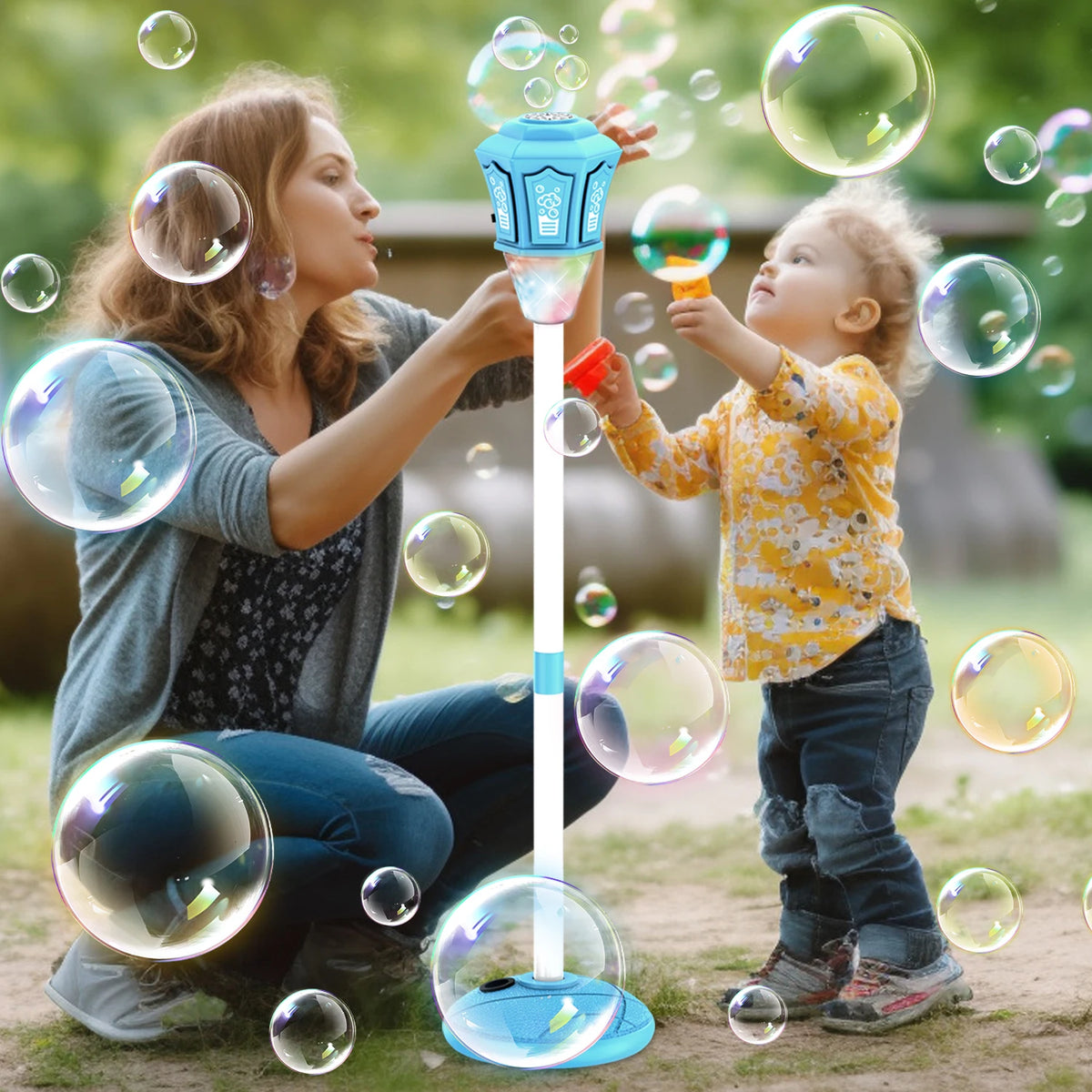A woman and a child are playing with an automatic outdoor bubble machine that produces large bubbles.