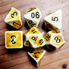 A collection of polyhedral dice, including d6 and d10 shapes, resting on a wooden surface.