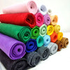 A collection of rolled soft felt fabric sheets in various colors including pink, red, green, purple, and yellow.