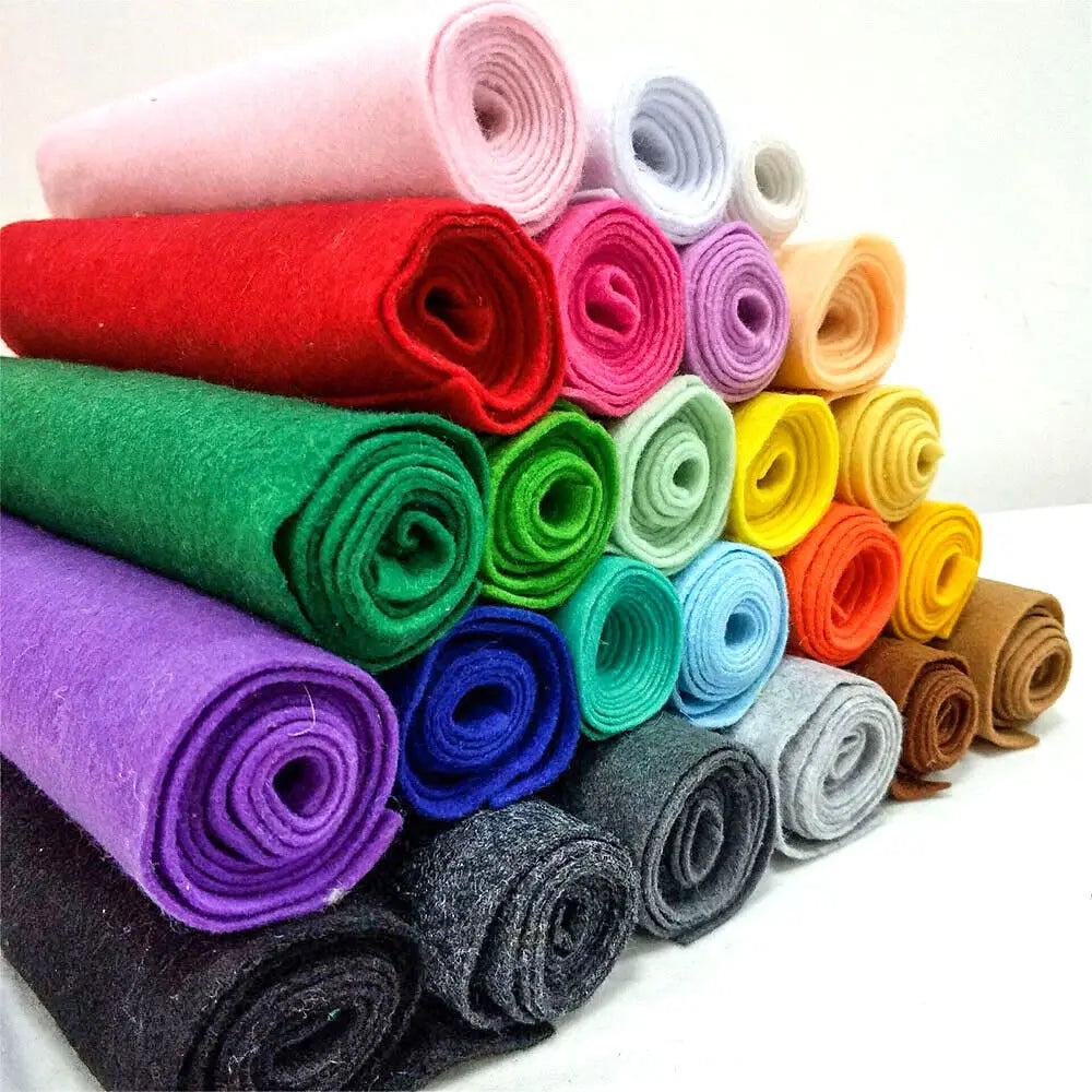 A collection of rolled soft felt fabric sheets in various colors including pink, red, green, purple, and yellow.