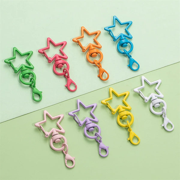 A collection of colorful lobster clasp keychains in various shades of green, pink, orange, and blue stars.