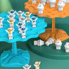 A set of white frog-shaped balance toys are displayed on an orange and blue tree structure.