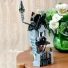 A detailed building block set of a haunted house featuring a spire and dark gray and black architectural elements.