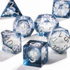 A collection of blue polyhedral dice, including a d20 and d12, with a sparkling galaxy finish.