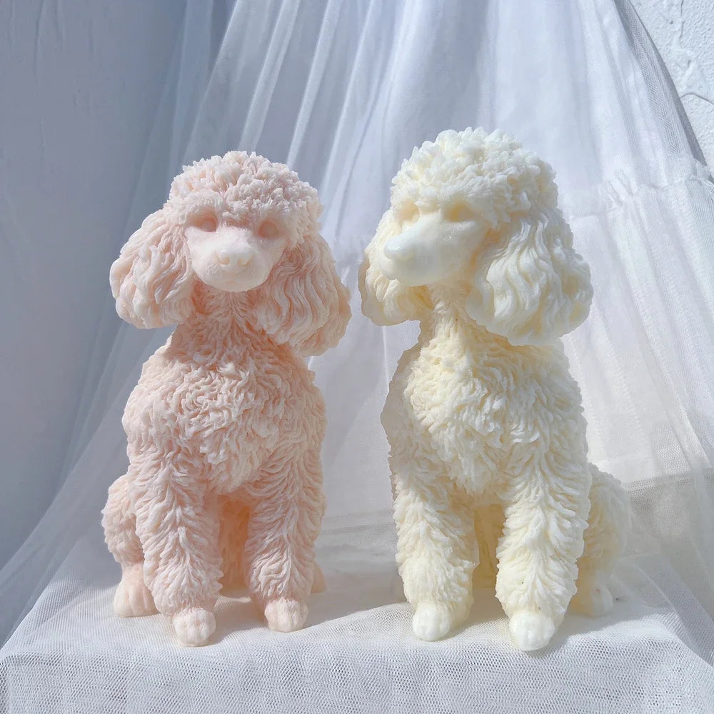 Two fluffy poodle dog silicone candle molds in pink and cream colors displayed on white fabric.