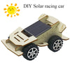 A wooden model kit of a solar racing car or lunar rover with a dark solar panel and large wheels.