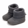 A pair of gray baby winter snow boots with fuzzy ball accents shown from the side.