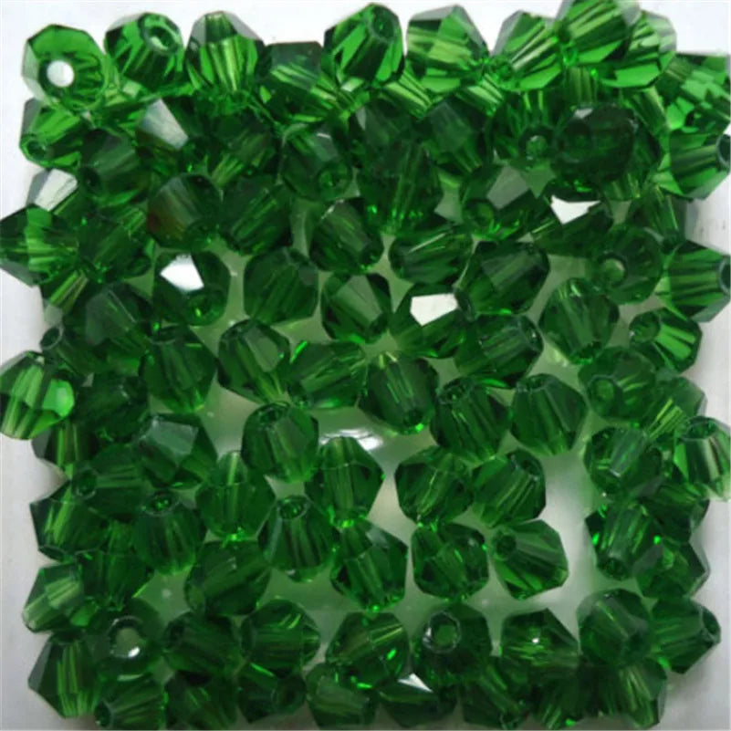 Green faceted glass bicone beads used for jewelry making
