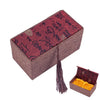 A rectangular wooden box with a textured lid featuring red and black script, accompanied by a smaller open box.