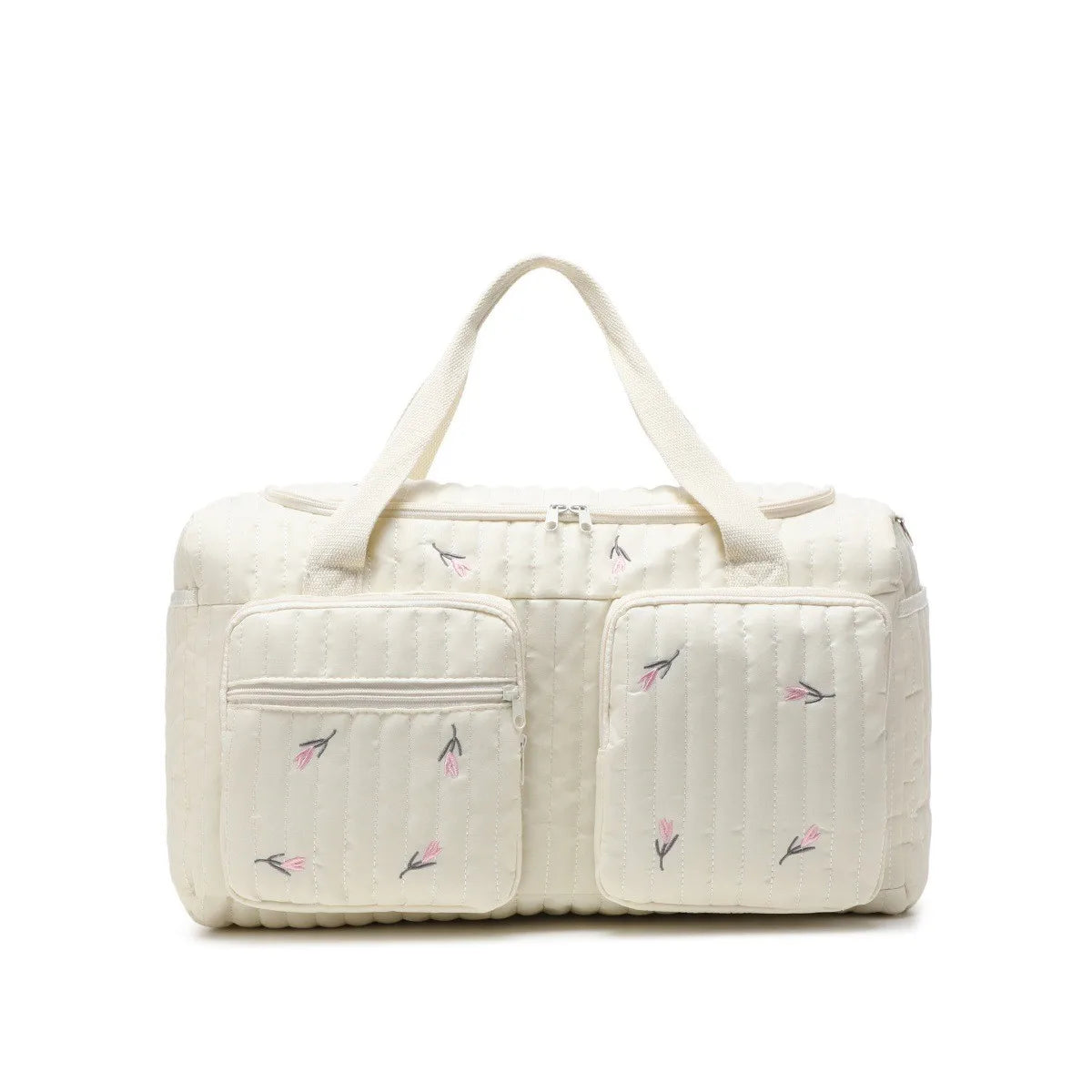 A cream-colored Enchanted Bear diaper bag with quilted texture and light pink floral embroidery.