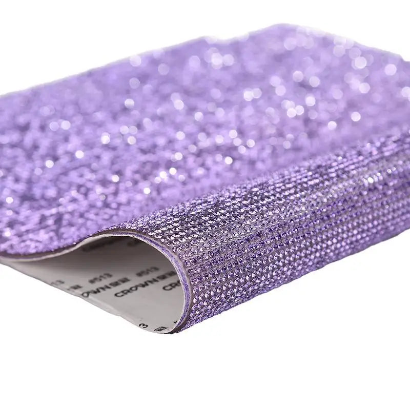 Purple sparkling rhinestone adhesive tape rolled up for DIY crafts and decor