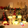 Battery-powered fairy lights shaped like Christmas trees illuminating a snowy scene.