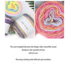 A close-up of colorful gradient rainbow yarn wound into a ball for knitting and crochet projects.