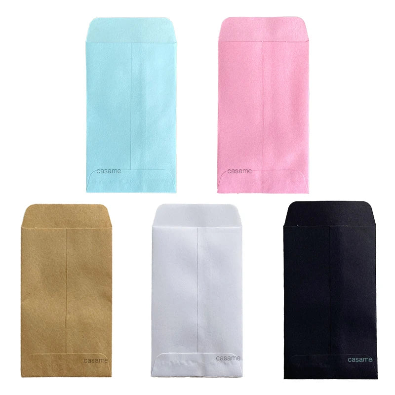 Four mini kraft paper gift bags in light blue, pink, tan, and black.