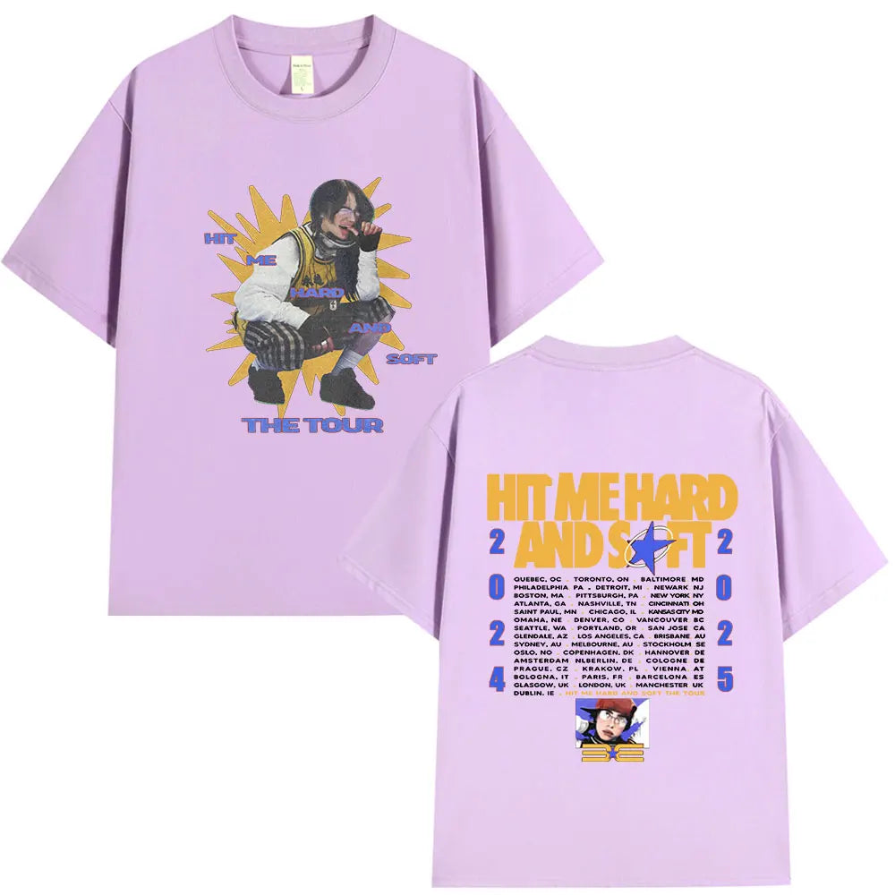 A light purple t-shirt featuring a graphic design related to the Hit Me Hard and Soft Tour.