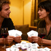Two people look at conversation starter cards for bonding and relationship discussions.