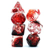A set of polyhedral dice made of red and clear crystal glass, displayed against a white background.