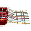 A collection of silicone pacifier clips in various colors, including red, green, pink, and yellow, arranged in a fan shape.