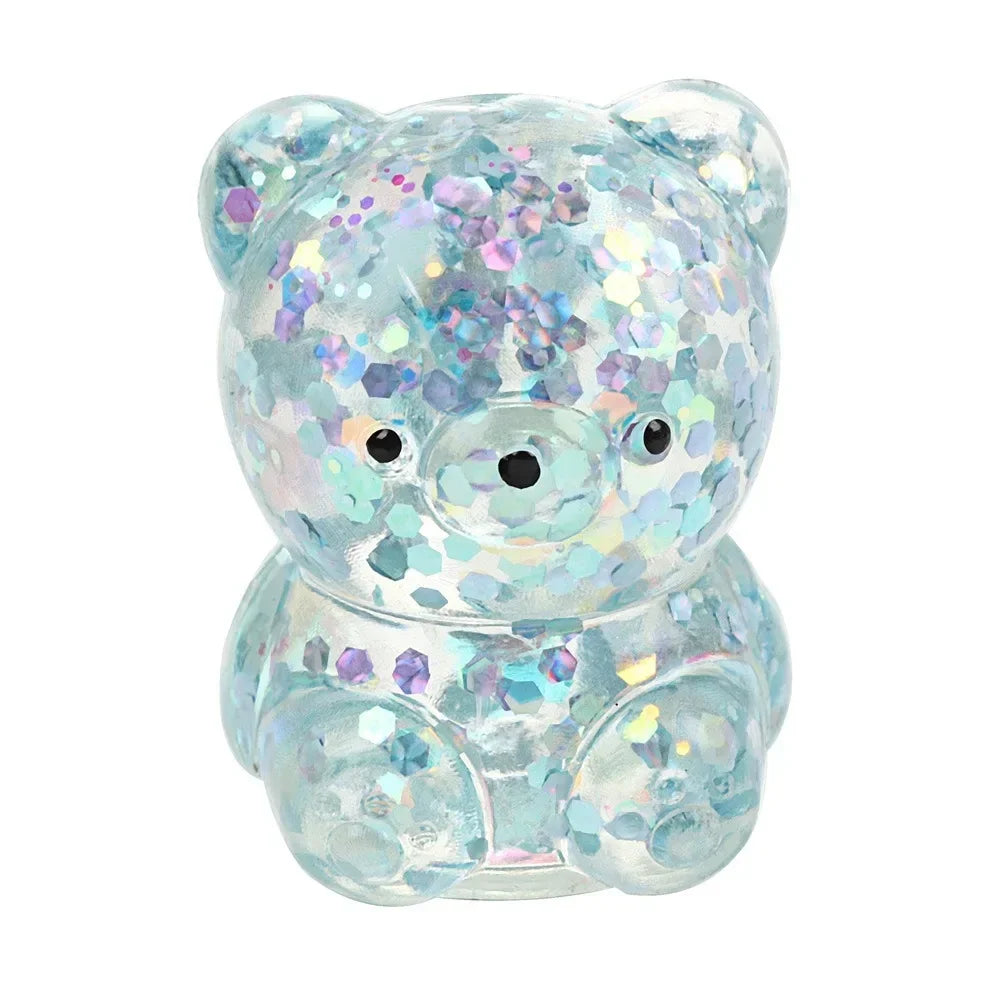 A clear silicone stress ball shaped like a bear covered in iridescent blue and purple water beads.