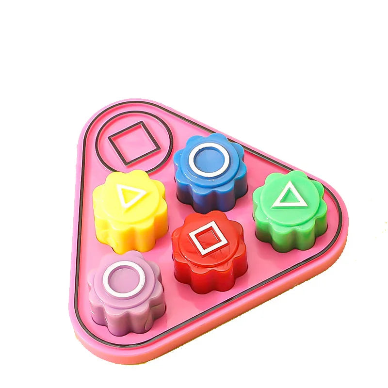 A pink plastic set of five colored gonggi stones for a traditional Korean game.