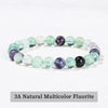 A bracelet made of 3A natural multicolor fluorite stones in various shades of green and purple.