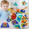 A colorful Montessori busy board cube toy with various sensory activities and attachments for toddlers.