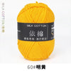 A ball of bright yellow milk cotton yarn labeled 60# 明黃 for knitting and crochet.