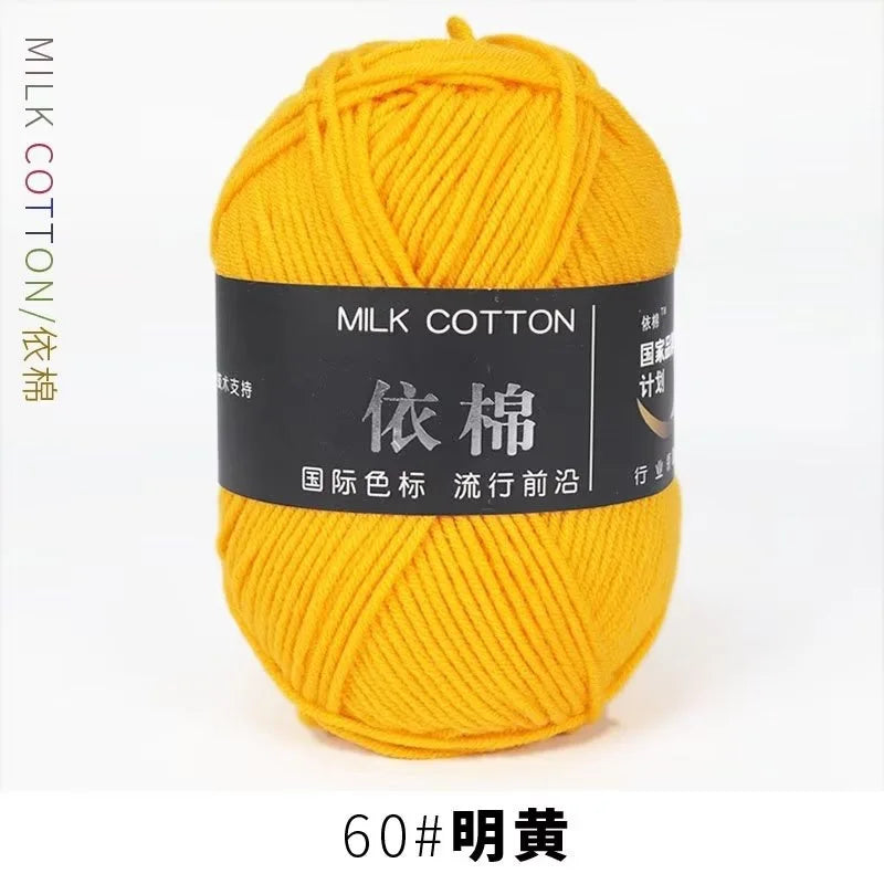 A ball of bright yellow milk cotton yarn labeled 60# 明黃 for knitting and crochet.