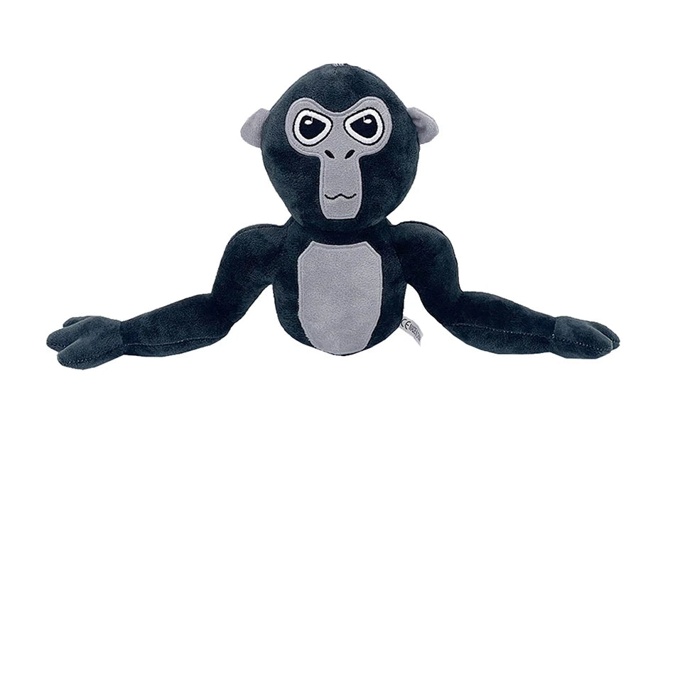 A dark gray and black plush toy of a monke gorilla with large eyes.
