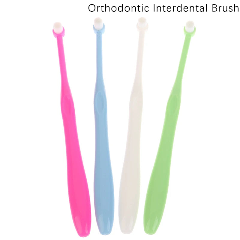 A set of four orthodontic interdental brushes in pink, blue, white, and green.