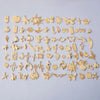 A collection of various gold-toned mixed metal charms and pendants for DIY jewelry making.