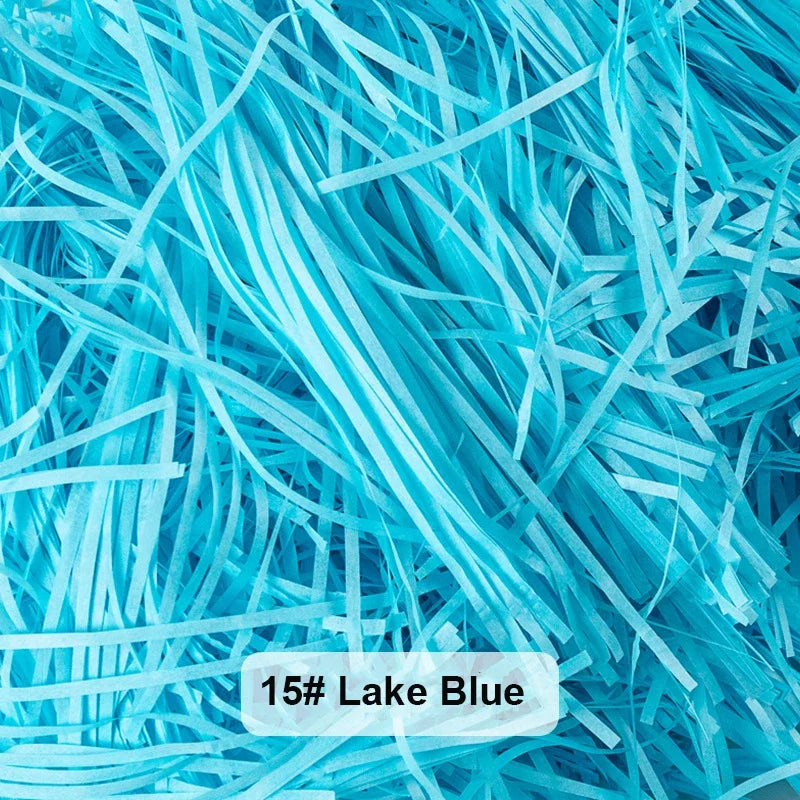 A pile of bright blue raffia paper shreds used for gift boxes and baskets.