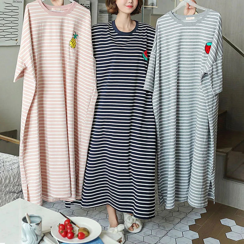 A woman models a pink and white striped short-sleeve lounge dress with a small fruit graphic.