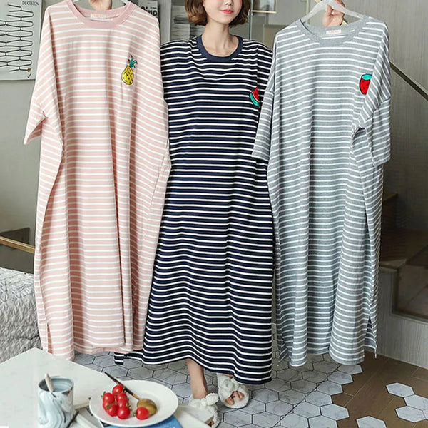 A woman models a pink and white striped short-sleeve lounge dress with a small fruit graphic.