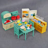 A 1:12 scale dollhouse furniture set featuring a kitchen with appliances, a dining table, and storage cabinets.