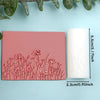 Pink clay texture rollers and a white roll demonstrating floral and leaf designs for handmade jewelry