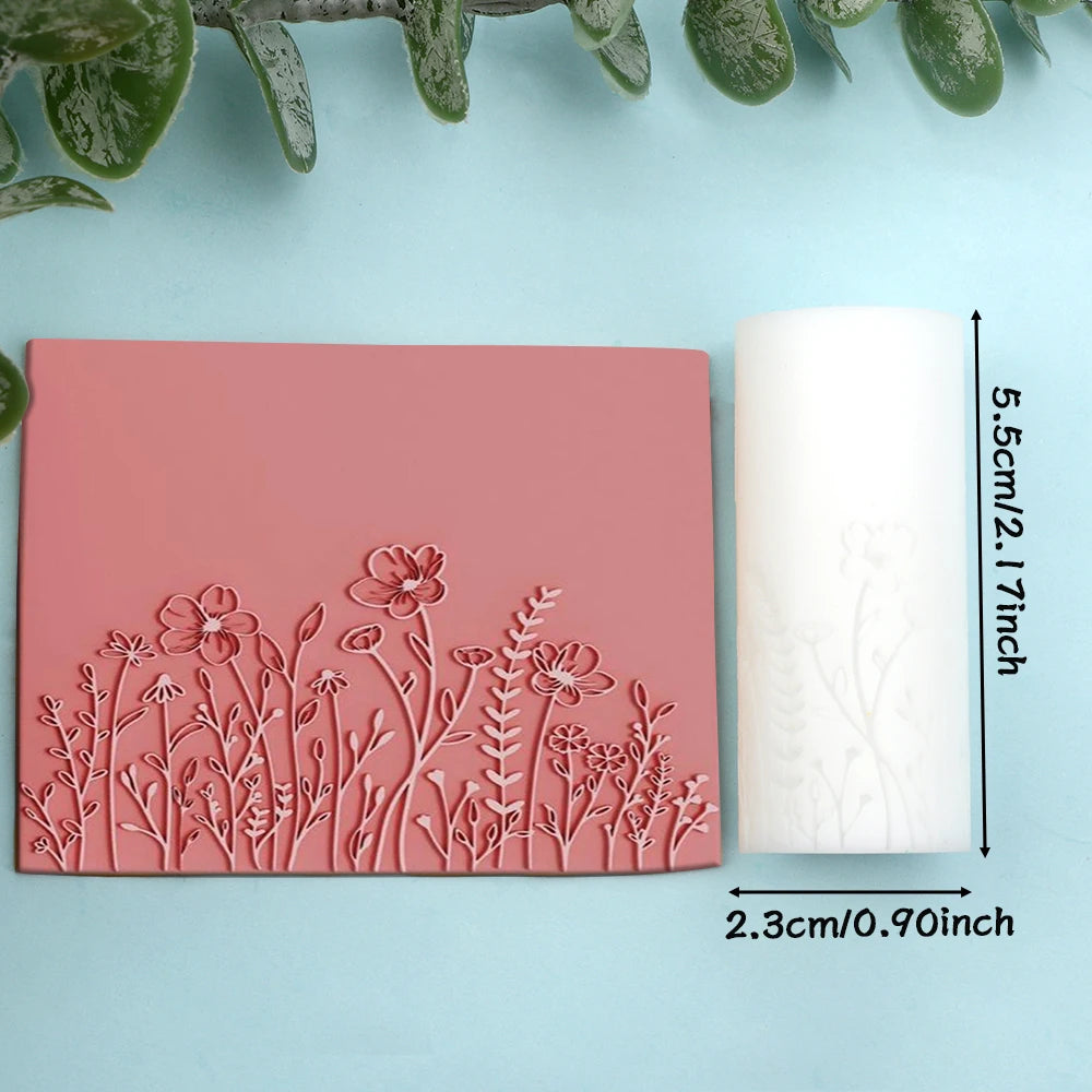 Pink clay texture rollers and a white roll demonstrating floral and leaf designs for handmade jewelry