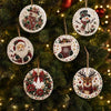 A close-up of various handmade Christmas diamond painting ornaments hanging on a green fir tree.