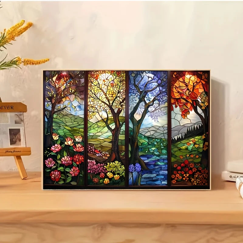 A framed stained glass art piece depicting a vibrant forest landscape with colorful trees and foliage.