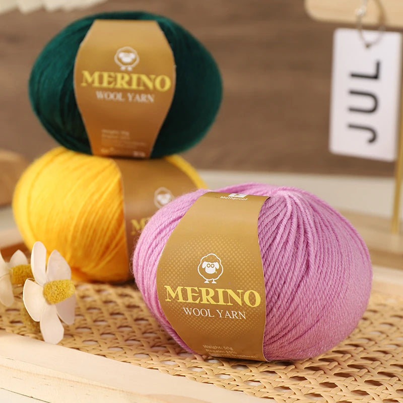 A stack of purple merino wool yarn skeins and a yellow yarn skein resting on a woven mat.