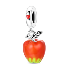 A silver fruit charm featuring a red apple with a green stem and a heart pendant.