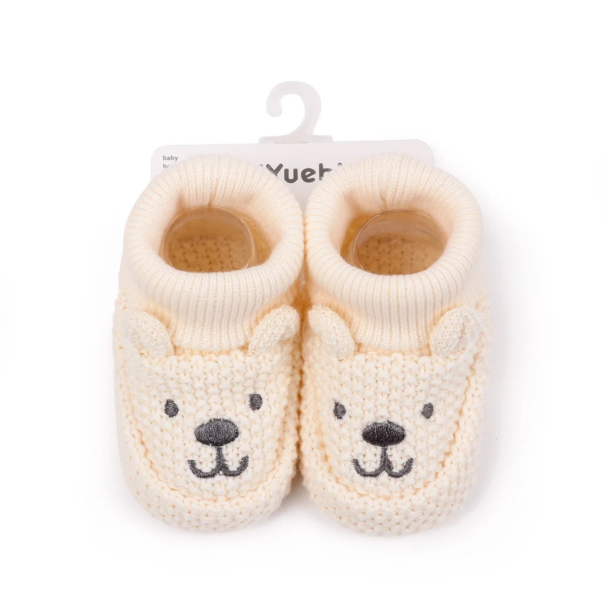 Pair of handmade knitted baby booties shaped like bears with non-slip soles
