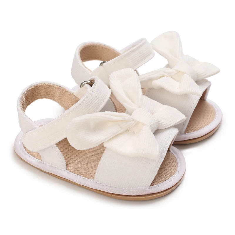 Pair of white breathable baby first walker sandals with soft anti-slip soles