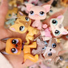 A hand holds a set of miniature pet animal figures in various colors and poses.
