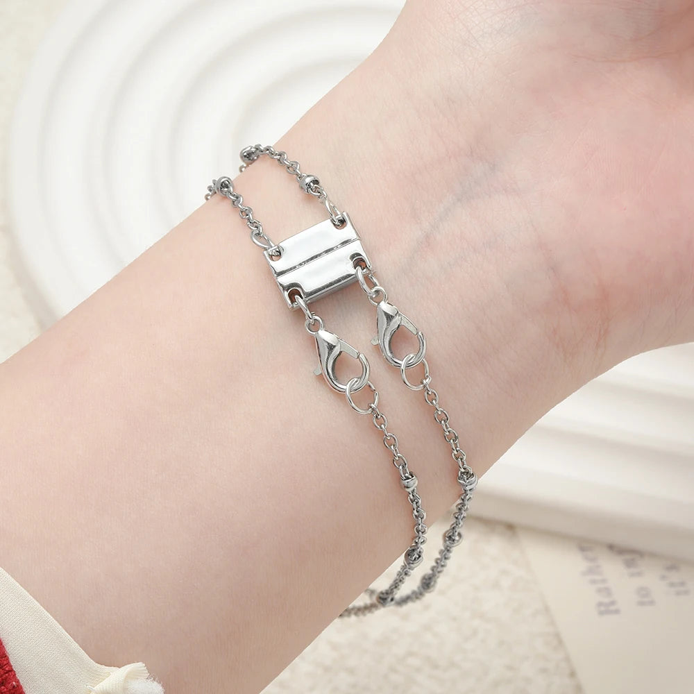 Silver magnetic layering clasps for necklaces and bracelets worn on a wrist.